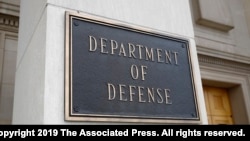 FILE - A photo shows a sign for the Department of Defense at the Pentagon building, in Arlington, Virginia, outside Washington, April 19, 2019. 