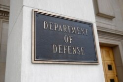 FILE - A photo shows a sign for the Department of Defense at the Pentagon building, in Arlington, Virginia, outside Washington, April 19, 2019.