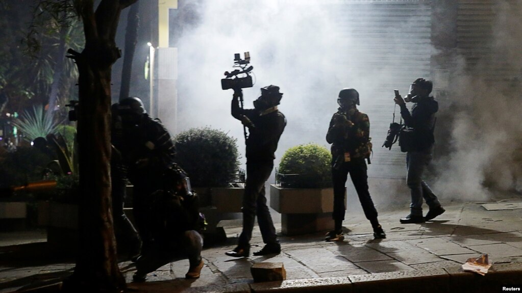 FILE - Journalists are seen during a protest in La Paz, Bolivia, on Oct. 24, 2019. Some 24 media workers were attacked while covering more recent protests, in November 2024. Analysts say the environment for the press in Bolivia is worsening.