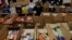 A worker prepares boxes of free food for distribution at the Chelsea Collaborative, which distributes 6 to 7 thousand of boxes of food a week in a city hard hit by the coronavirus disease (COVID-19) outbreak, in Chelsea, Massachusetts, July 9, 2020.