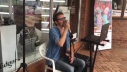 Musician Alex Entertains People at Sam Levy’s Village