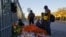 Migrants speak next to an altar outside the migrant detention center where several migrants died after a fire broke out late on Monday, in Ciudad Juarez, Mexico, March 29, 2023.