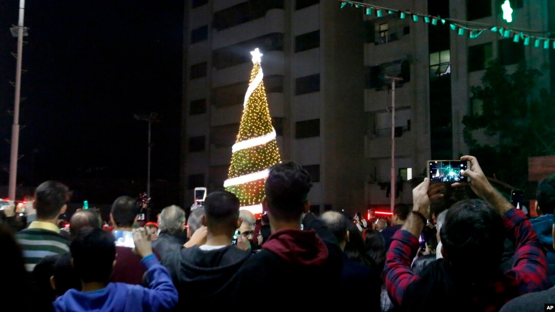 FILE - Palestinian Christians attend a Christmas tree lighting celebration in Gaza City, Dec. 3, 2019. 