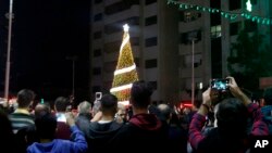FILE - Palestinian Christians attend a Christmas tree lighting celebration in Gaza City, Dec. 3, 2019. 