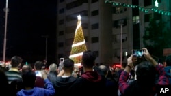 FILE - Palestinian Christians attend a Christmas tree lighting celebration in Gaza City, Dec. 3, 2019. 
