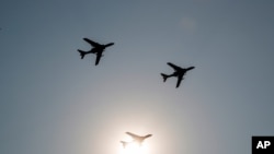 China's H-6 bomber jets fly in formation past the sun during a parade to commemorate the 70th anniversary of the founding of Communist China in Beijing, Oct. 1, 2019. 