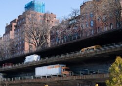Vehicles drive along the Brooklyn Queens Expressway, part of the city's aging infrastructure, beneath the Brooklyn Heights promenade, April 6, 2021, in New York.