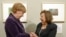 Artist Nelly Toll (r) shares a light moment with German Chancellor Angela Merkel as Merkel inaugurates the exhibition "Art from the Holocaust - 100 works from the Yad Vashem collection" in the German Historical Museum in Berlin, Jan. 25, 2016.