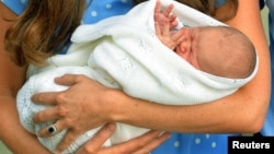 Britain's Prince William and his wife Catherine, Duchess of Cambridge appear with their baby son outside the Lindo Wing of St Mary's Hospital, in central London, July 23, 2013. 