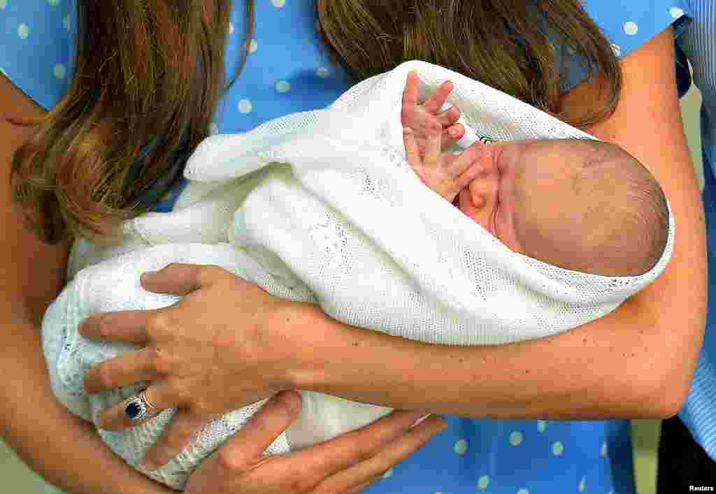 Happyland models of Britain's Prince William and his wife Catherine, Duchess of Cambridge, and their newborn baby, are seen on sale in a Mothercare store, in central London July 23, 2013. The world was awaiting the first glimpse of Britain's new prince on