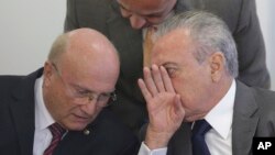 Brazil's President Michel Temer (R) speaks with his Justice Minister Osmar Serraglio (L) during a ceremony at the Planalto presidential palace, in Brasilia, Brazil, April 12, 2017. Brazil's Supreme Court announced corruption investigations into eight ministers and dozens more top politicians in a sweeping decision that affects almost one third of embattled President Michel Temer's Cabinet and many of his top allies.