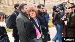 Gisele Pelicot, the victim of an alleged mass rape orchestrated by her then-husband Dominique Pelicot, arrives with her lawyers Stephane Babonneau and Antoine Camus to attend the verdict in the trial at the courthouse in Avignon, France, Dec. 19, 2024. 