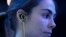 FILE - A young woman is seen wearing headphones at the Consumer Electronics Show in Las Vegas Jan. 6, 2015.