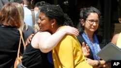 Victims of the 2017 car attack by James Alex Fields Jr. hug outside court after his sentencing in Charlottesville, Va., June 28, 2019. Fields was sentenced to life in prison for his role in a car attack during a white supremacist rally in 2017.