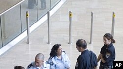 Israeli police officers stand at the arrival hall at Ben Gurion airport near Tel Aviv , July 6, 2011
