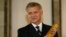Marek Belka, governor of the Central Bank of Poland, holds gold at bank headquarters, Warsaw, June 17, 2011.