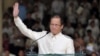 (FILES) This file photo taken on June 30, 2010 shows Philippine President Benigno Aquino waving to the crowd after delivering his inaugural speech at the Quirino Grandstand in Manila. - Benigno "Noynoy" Aquino, the Philippines' former president who…