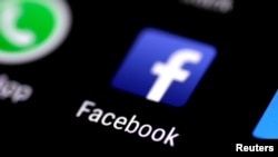 FILE - The Facebook application icon is seen on a phone screen in this Aug. 3, 2017, illustration photo. 