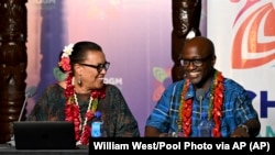 Commonwealth Secretary General Patricia Scotland, left, chats with Rwanda's Minister of Foreign Affairs Olivier Nduhungirehe at the Commonwealth Heads of Government Meeting in Apia, Samoa, Oct. 26, 2024. (William West/Pool Photo via AP)