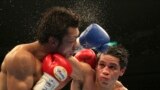 Japanese champion Akira Yaegashi, (l), gets a punch from Mexican challenger Edgar Sosa in the 10th round of their WBC flyweight boxing title bout in Tokyo. Yaegashi defended his world title by a unanimous decision.