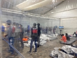 Detainees are seen in a Customs and Border Protection (CBP) temporary overflow facility in Donna, Texas, March 20, 2021, in this photo provided by the Office of Rep. Henry Cuellar, D-Texas.
