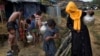 FILE - Rohingya Muslims collect water from a tube well at a refugee camp at Cox's Bazar Ukhia area, Bangladesh, Sept. 9, 2017.