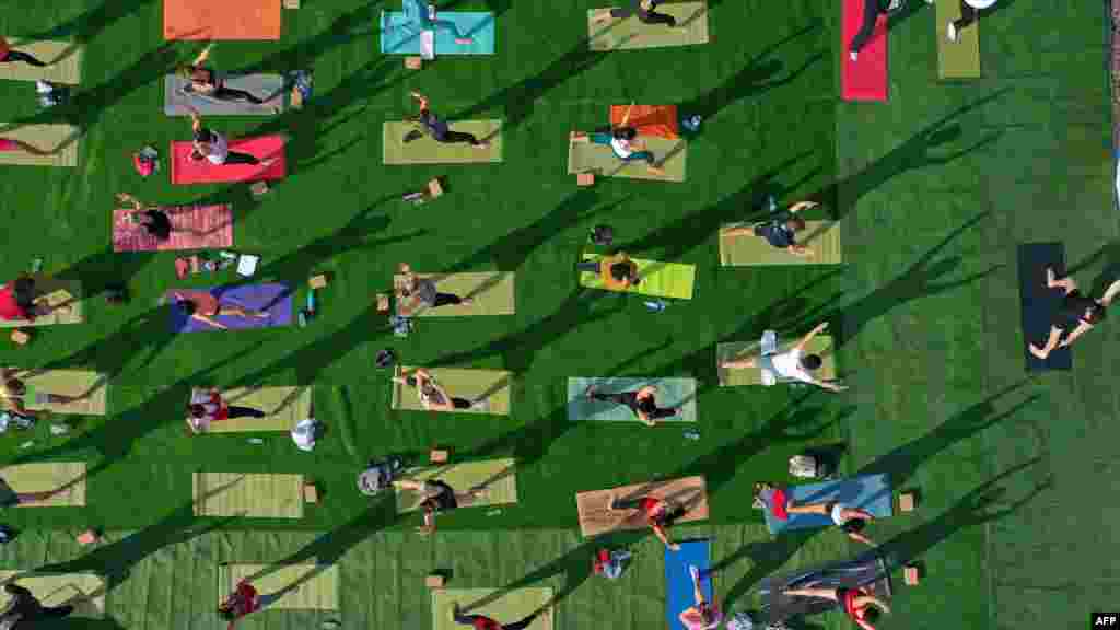 People attend a yoga class on a small island at Hatta Lake in the United Arab Emirates.