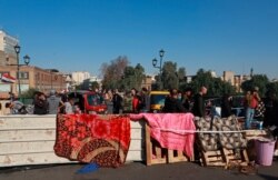 Anti-government protesters stage a sit-in on the Ahrar Bridge, in Baghdad, Iraq, Nov. 20, 2019.