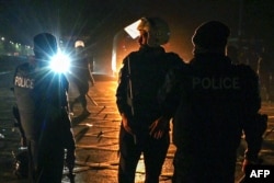 Police stand guard after security forces conducted an overnight operation against the supporters of jailed former Prime Minister Imran Khan's Pakistan Tehreek-e-Insaf party during a protest in Islamabad on Nov. 27, 2024.