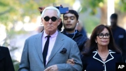 Roger Stone, left, with his wife Nydia Stone, arrives at the federal court in Washington, Nov. 5, 2019.