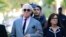 Roger Stone, left, with his wife Nydia Stone, arrives at the federal court in Washington, Nov. 5, 2019.