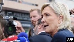 French politician Marine Le Pen answers journalists during her political re-entry at her parliamentary headquarter in Henin-Beaumont, northern France, Sept. 8, 2024. On Sunday, she urged President Macron to hold a referendum on key issues such as immigration.