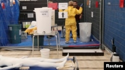 MSF volunteer receives training on how to handle personal protective equipment during Ebola response courses, Brussels, Oct., 15, 2014.