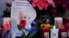 Candles are seen near pictures of Pope Francis outside the Agostino Gemelli Polyclinic in Rome, Feb. 23, 2025, where the pontiff has been hospitalized since Feb. 14.