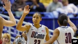 University of Connecticut's forward Maya Moore is congratulated by teammates against Florida State during the second half of their NCAA Women's basketball game in Hartford, Connecticut, 21 Dec 2010.