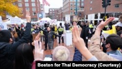 Pro-Thai democracy protesters make a three-finger salute during a clash between pro-Thai democracy protesters and Thai royalists during the demonstration at King Bhumibol Adulyadej Square in Cambridge, MA Nov 1, 2020.