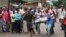 Men carry a dead body in the Nyakabiga neighborhood of Bujumbura, Burundi, where a number of people were found shot dead a day after the government said an unidentified group had carried out coordinated attacks on three military installations, Dec. 12, 2015.