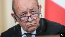 FILE - France's Foreign Minister Jean-Yves Le Drian listens during a news conference after his talks with Russian counterpart Sergey Lavrov, in Moscow, Sept. 8, 2017.