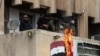 Anti government forces set the Syrian flag on fire in the city of Salamiyah in the central Hama governorate, Dec. 7, 2024.