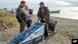 FILE - In this Sept. 2, 2015 file photo President Barack Obama meets with John Baker, left, the 2011 Iditarod winner on Kotzebue Shore Avenue, which has dealt with erosion problems, in Kotzebue, Alaska. On Dec. 9, 2016, Obama used his executive powers to add protections to waters off Alaska's west coast. Obama will leave behind a host of disputed actions and unfinished business on the environment, from blocked energy leases and mining projects to recent pollution restrictions and decisions on hundreds of potentially-imperiled species. Republicans emboldened by Donald Trump's victory are gearing up to reverse many of the administration's signature environmental moves.