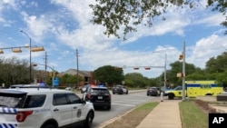 Police and emergency personnel work at the scene of a fatal shooting, in Austin, Texas, April 18, 2021. 