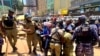 Ugandan opposition leader and singer Robert Kyagulanyi Ssentamu, known as Bobi Wine, is detained by riot-policemen during an anti-government demonstration in Kampala, Uganda, March 15, 2021.