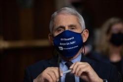 FILE - Dr. Anthony Fauci, Director of the National Institute of Allergy and Infectious Diseases, listens during a Senate Senate Health, Education, Labor, and Pensions Committee Hearing on the federal government response to COVID-19, Sept. 23, 2020.
