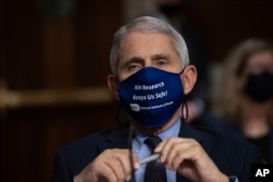 FILE - Dr. Anthony Fauci, Director of the National Institute of Allergy and Infectious Diseases, listens during a hearing on Capitol Hill, Sept. 23, 2020.