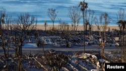 The charred remains of a trailer park are seen along a beach, following the Palisades Fire, at the Pacific Palisades neighborhood in Los Angeles, California, Jan. 15, 2025. 