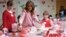 First lady Melania Trump, center, helps to fill candy boxes during a visit to the National Institutes of Health to see children at the Children's Inn in Bethesda, Md., to celebrate Valentine's Day, Feb. 14, 2019.
