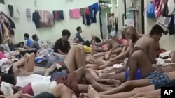 In this photo provided on condition of anonymity, Uyghur detainees who say they are facing deportation back to China, where they fear persecution and even death, sit in an immigration detention center in Bangkok, Thailand, in February 2024.