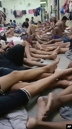 FILE - In this photo provided on condition of anonymity, Uyghur detainees sit in an immigration detention center in Bangkok, Thailand, in February 2024.