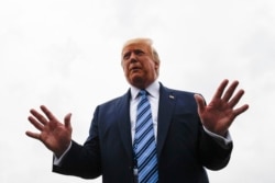 President Donald Trump talks to reporters at Morristown Municipal Airport in Morristown, N.J., Aug. 13, 2019.