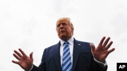 President Donald Trump talks to reporters at Morristown Municipal Airport in Morristown, N.J., Aug. 13, 2019.